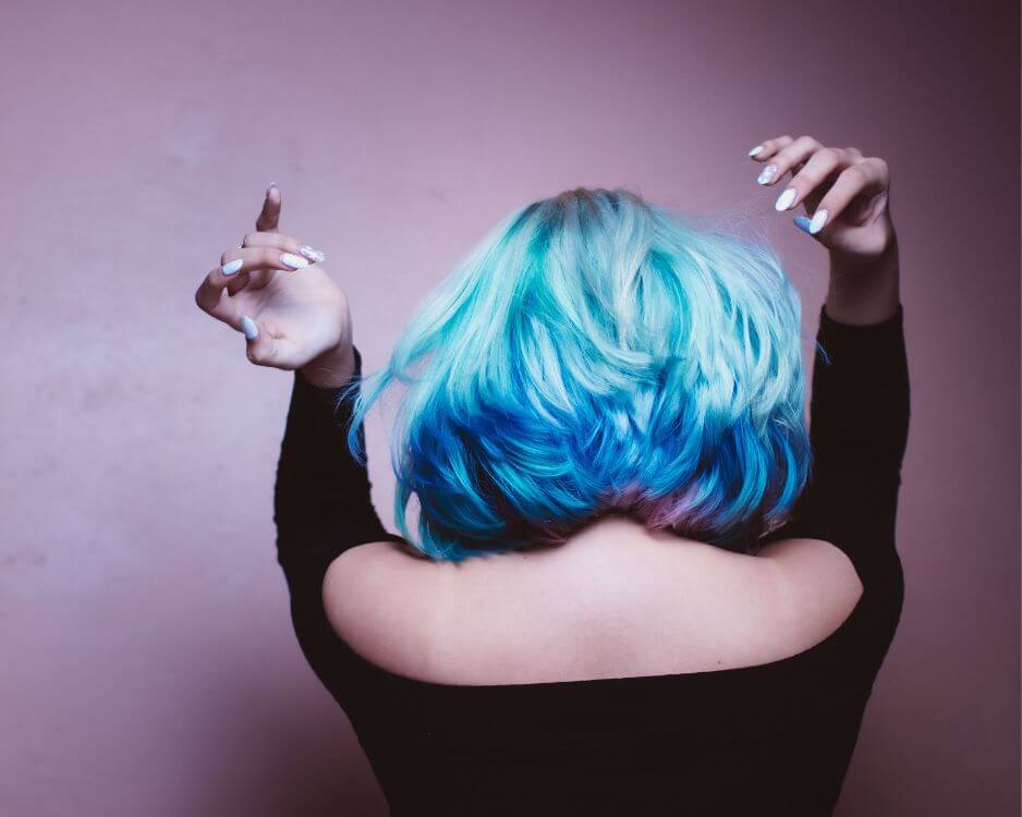 woman with black top and blue hair dancing
