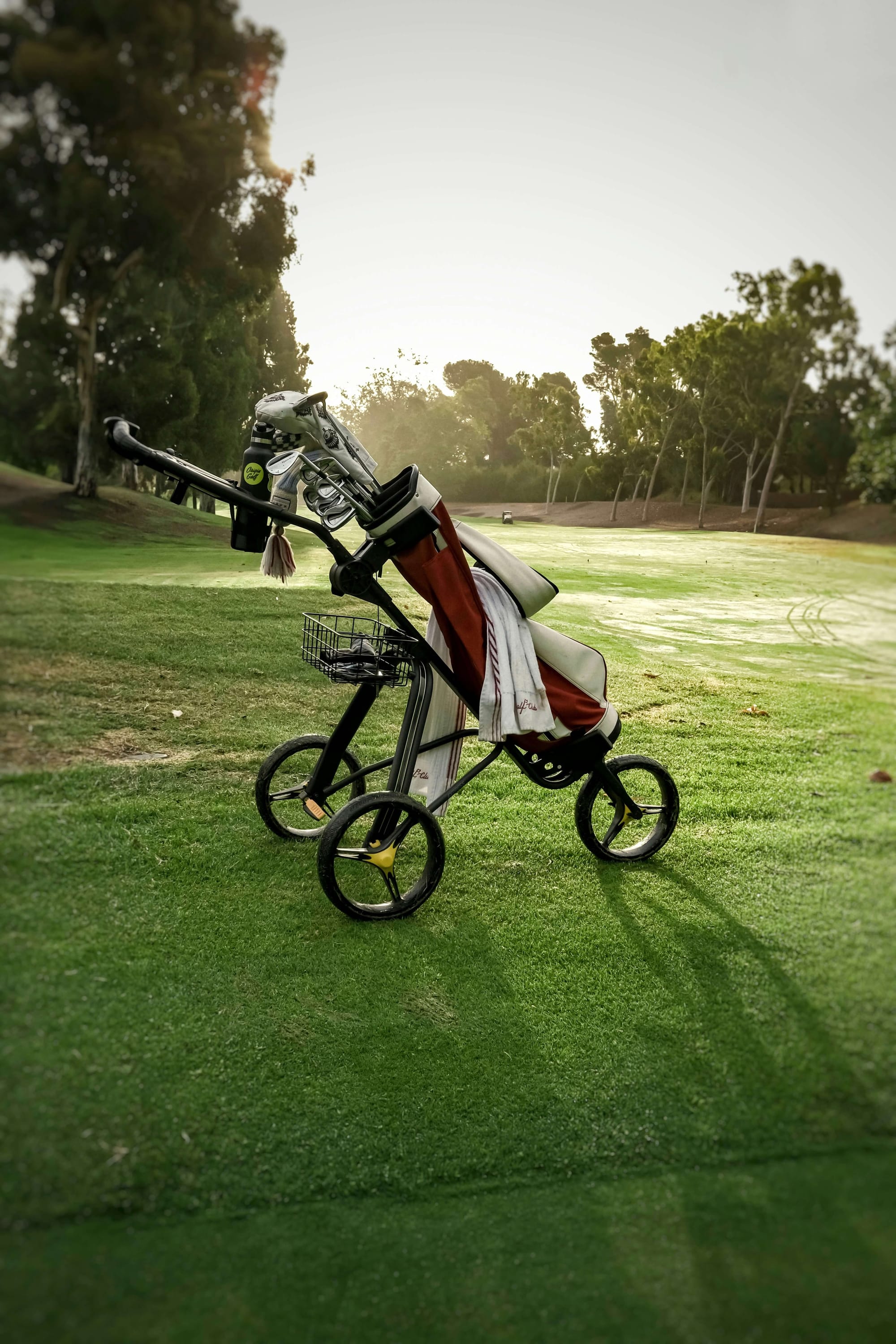 red golf bag with push cart