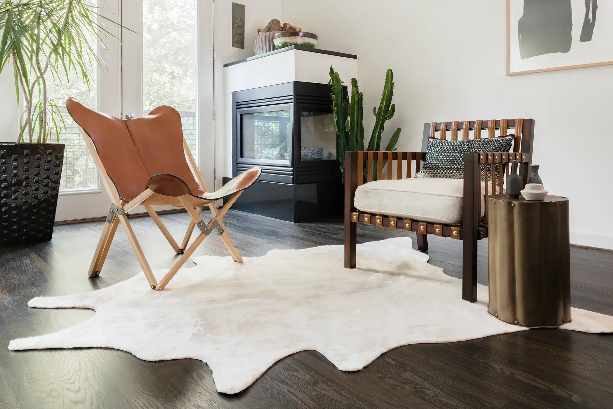 light tan cowhide rug by fireplace